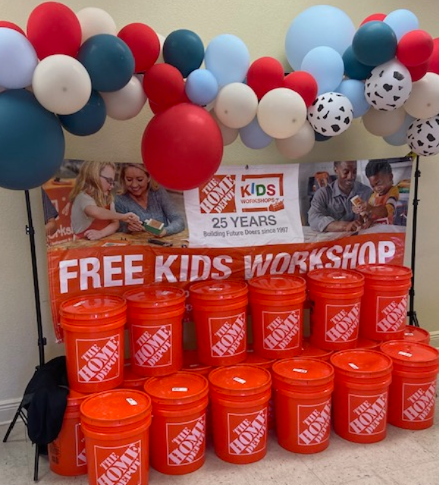 Balloons. Home Depot banner and bucket.