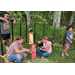 Adults and children standing with goats.