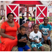 A family in front of a farm backdrop.