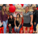 A group of people  in front of a Home Depot Display.