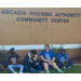 Kids sitting outside of the Arcadia Community Center.