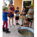 Kids using a cane pole to fish.