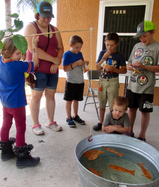 Kids using a cane pole to fish.