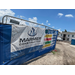 Gate with a sign attached for Marner Construction in front of the construction site for Hermosa.