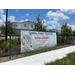 View of fence with a sign for Cypress Gardens Apartments.